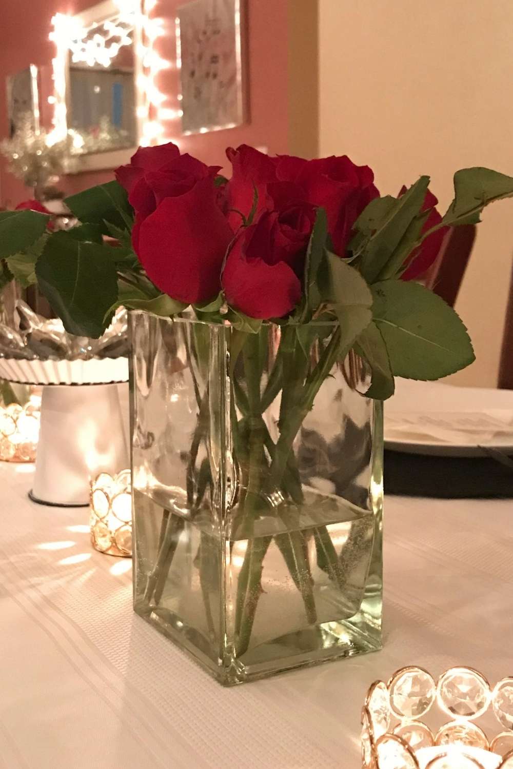 Red roses in a cube vase as a centerpiece as a jazz themed party decoration