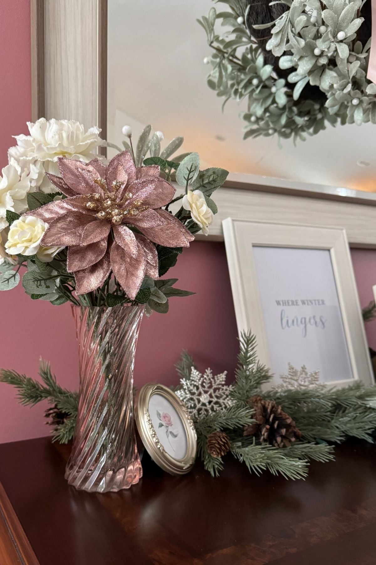 Blush and ivory flowers in a pink glass vase.