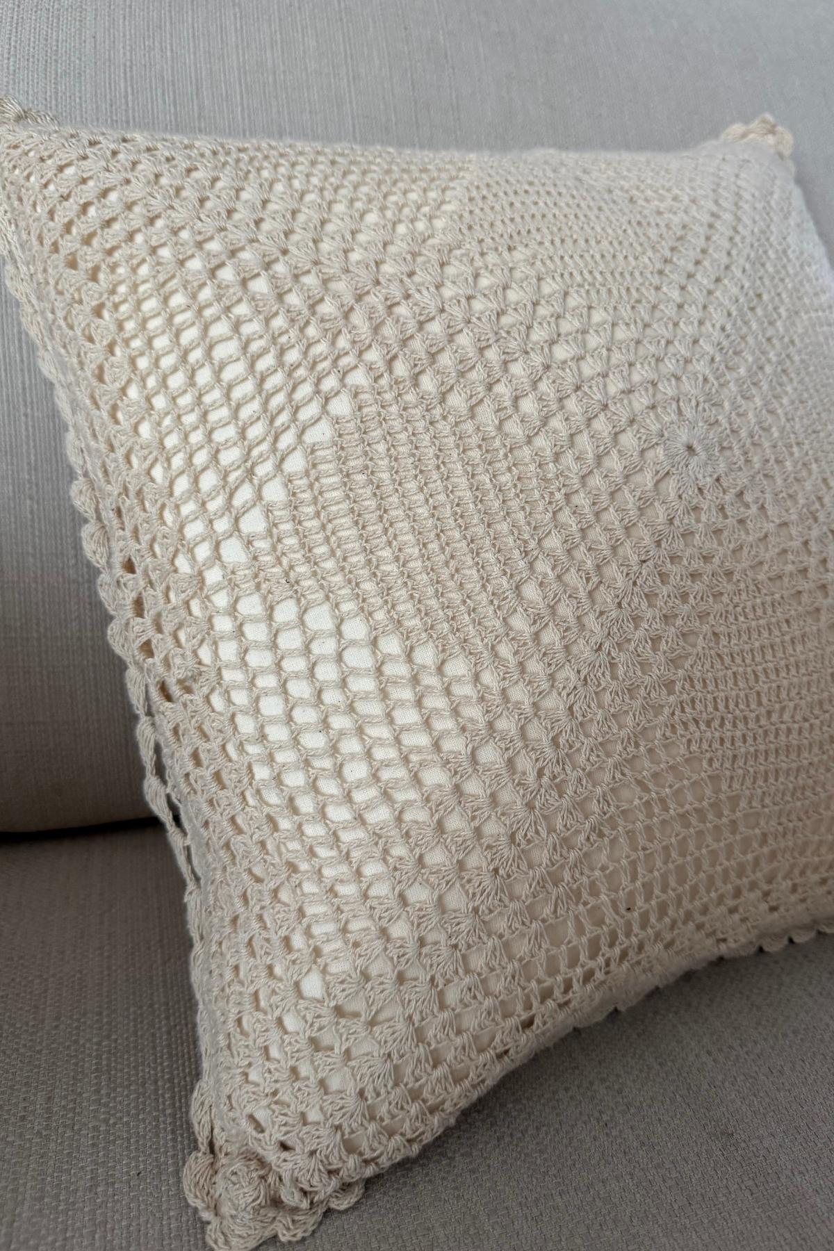 Soft white crocheted throw pillow