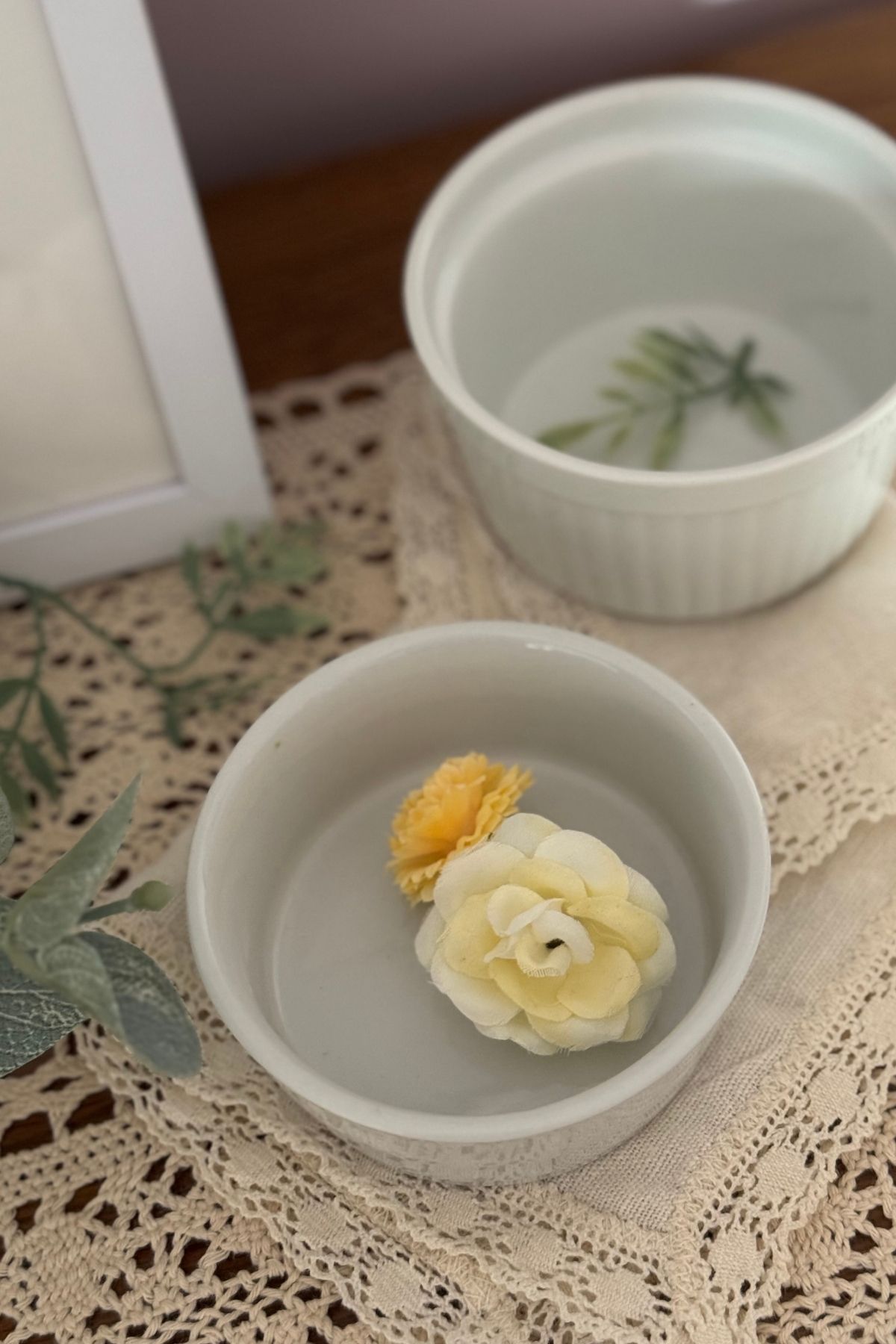 Small floral accents and lace textures in a soft spring bedroom vignette