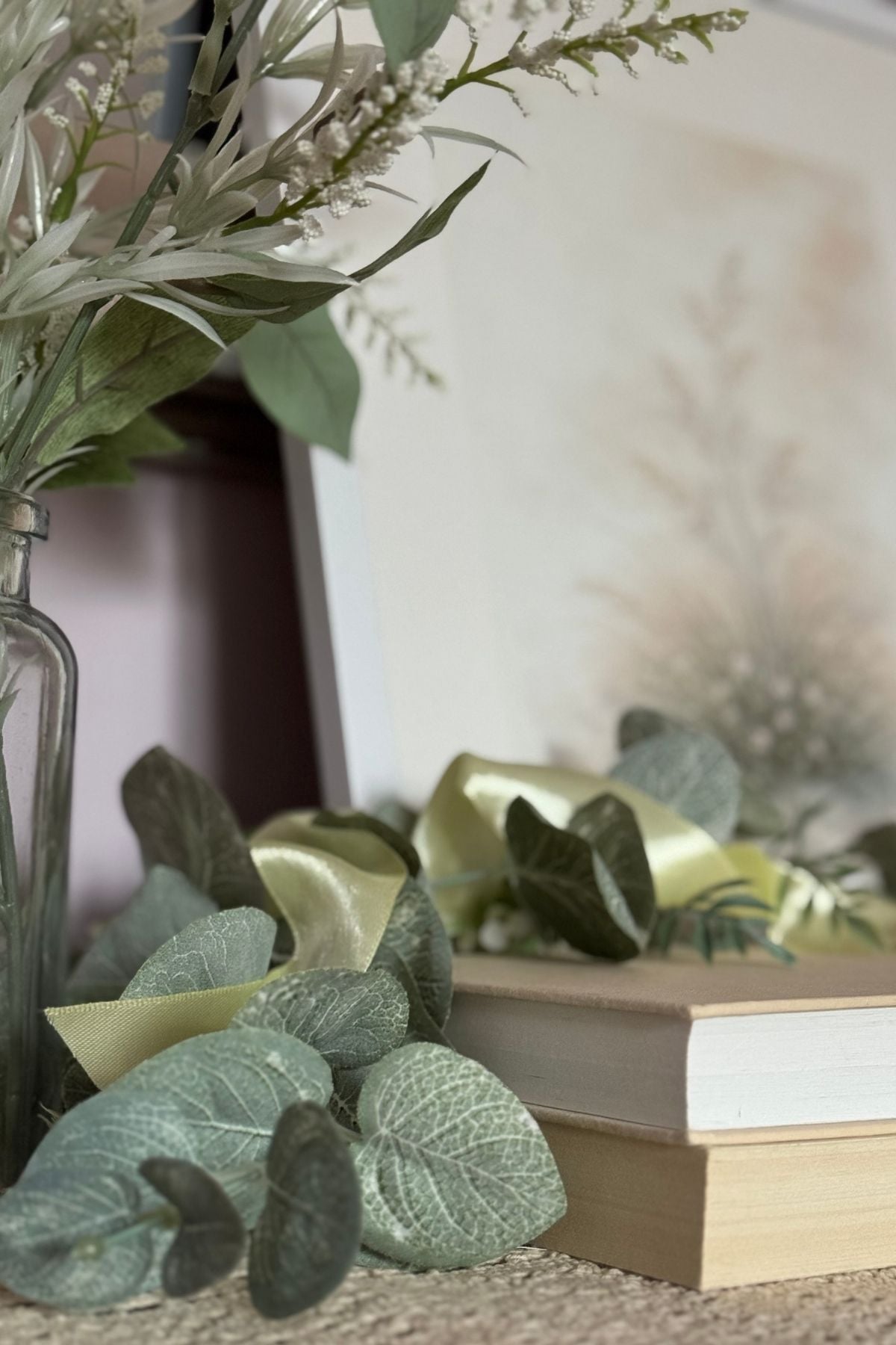 Soft yellow ribbon woven through greenery in spring bedroom styling
