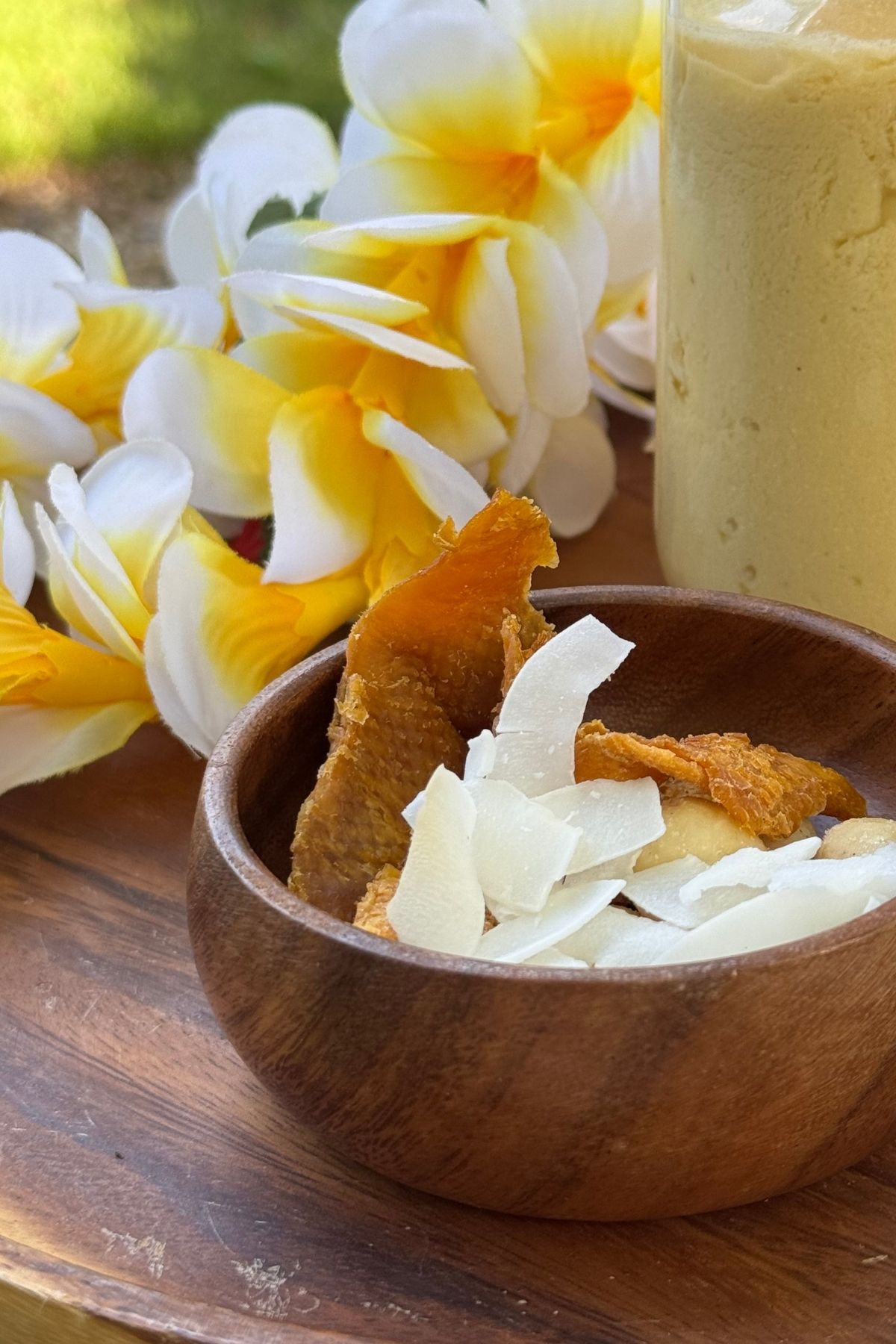 Simple luau snack in a dip-size acacia wood bowl: dried mangos, coconut chips, macadamia nuts