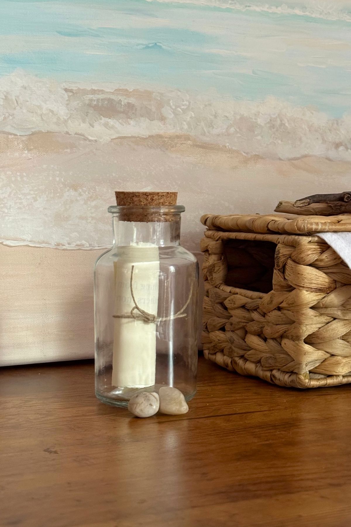 Message in a bottle with a couple of pebbles next to it.