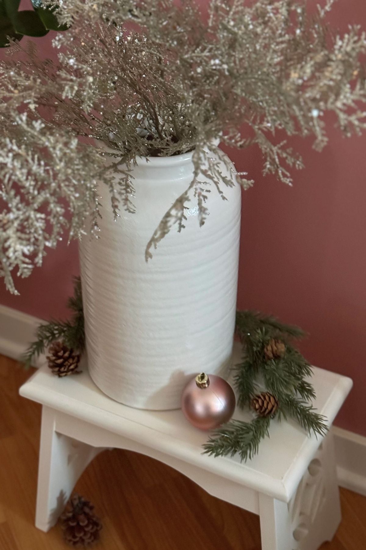 Christmas vignette for a cottage style home (2) Cream crock filled with silver branches above evergreen twigs, baubles, and a pinecone