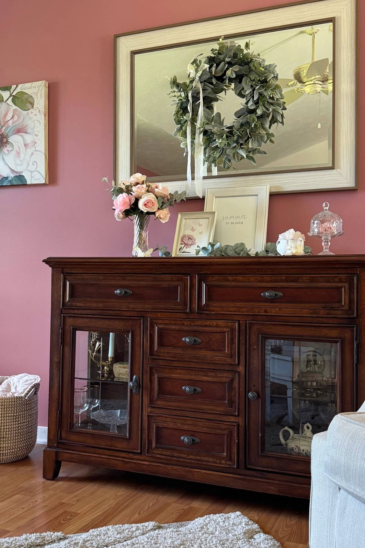 dark wood sideboard in a living room Dark wood sideboard in a living room decorated with blush, sage, and ivory.