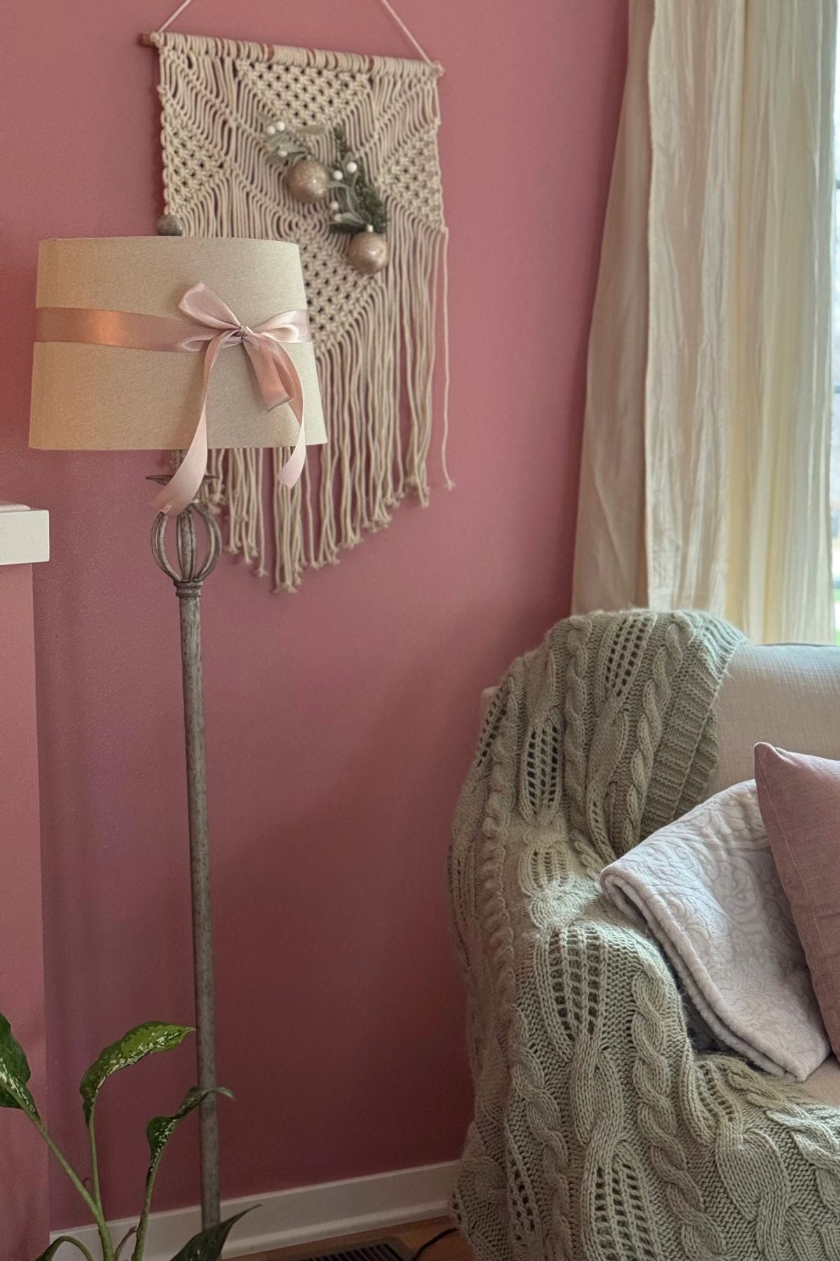 floor lamp decorated for Christmas Floor lamp decorated with a blush satin ribbon, standing in the living room reading nook