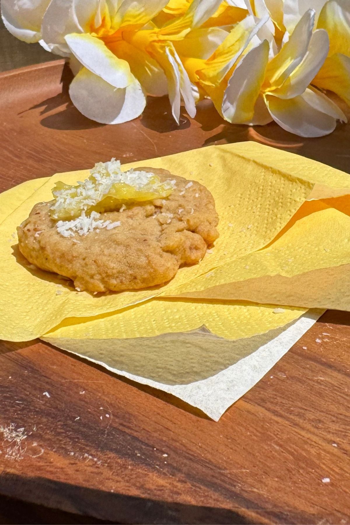 Shortbread cookie topped with crushed pineapple and sprinkled with coconut flakes