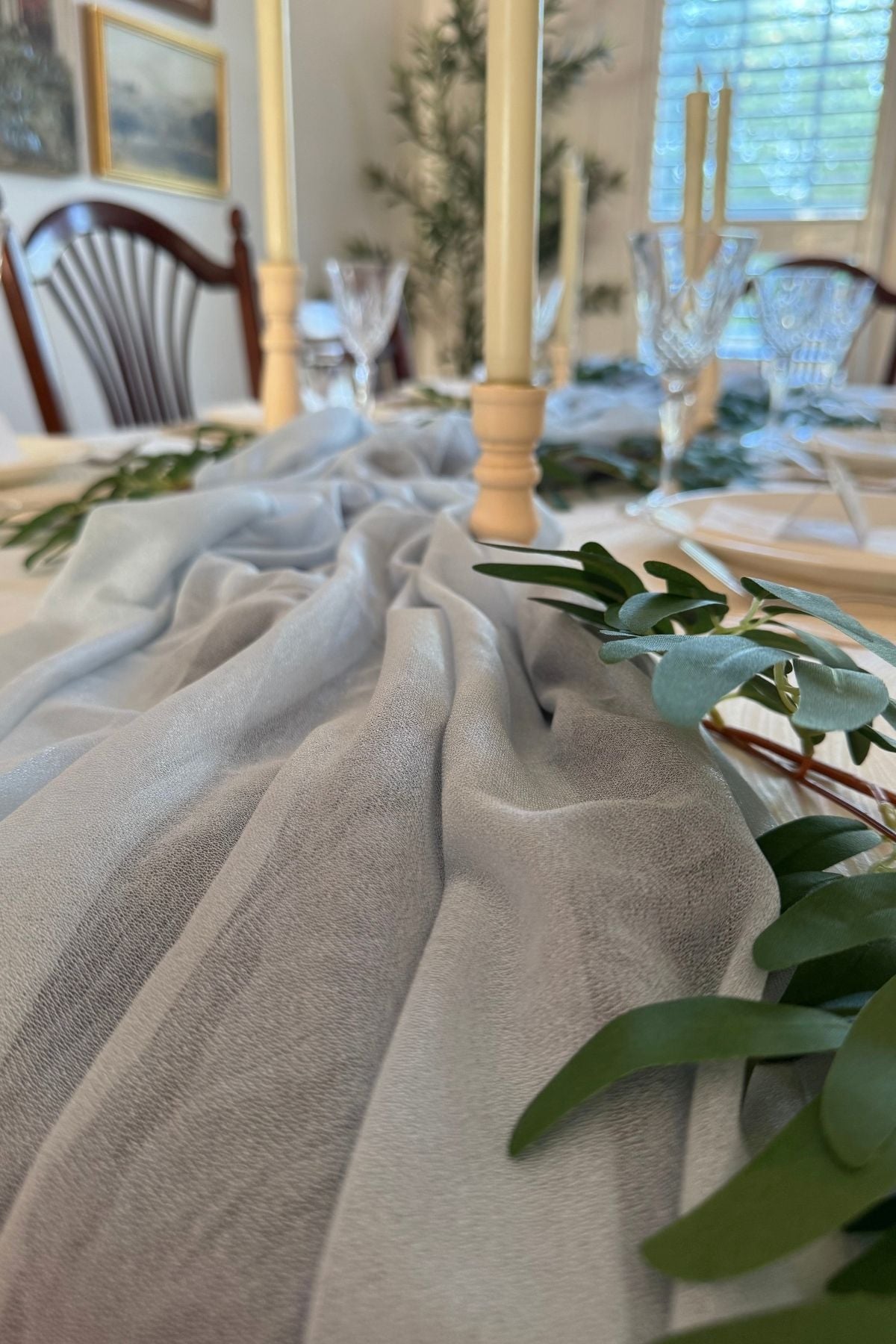 chiffon river table runner and greenery Greenery following along the curves of the chiffon table runner forming a Rivendell river.