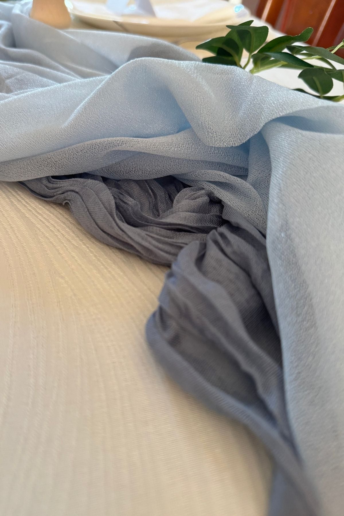 layered-blue-river-table-runner Dusty blue cheesecloth layered beneath pale blue chiffon to give the river table runner depth and variation