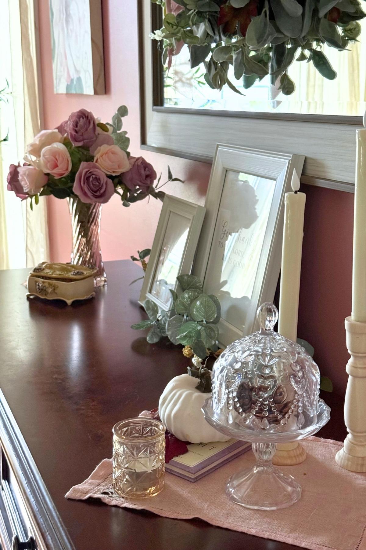 autumn sideboard decor (1) Autumn sideboard decor featuring faded roses, glass cloche, votive candle and autumn details.