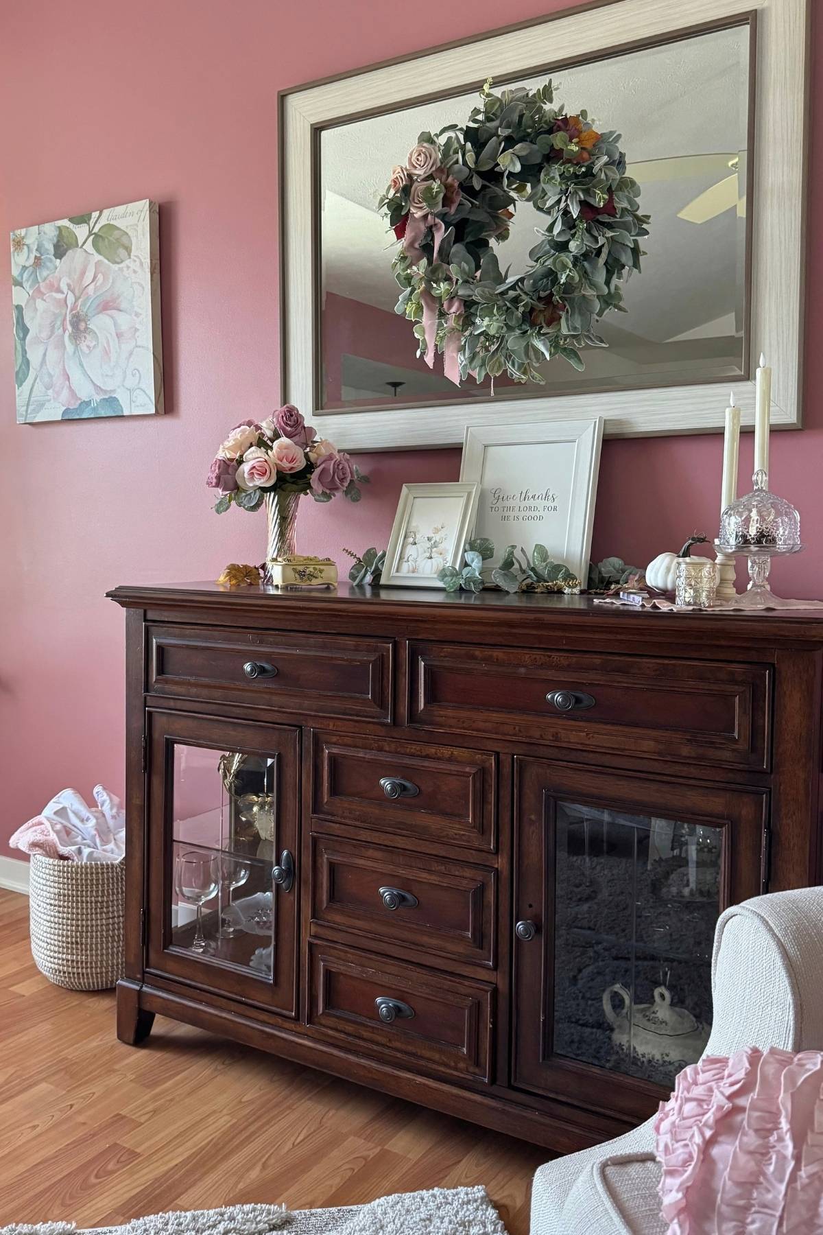 autumn sideboard in the living room A dark wood sideboard decorated with faded rose, autumn signs, candles, and other fall details