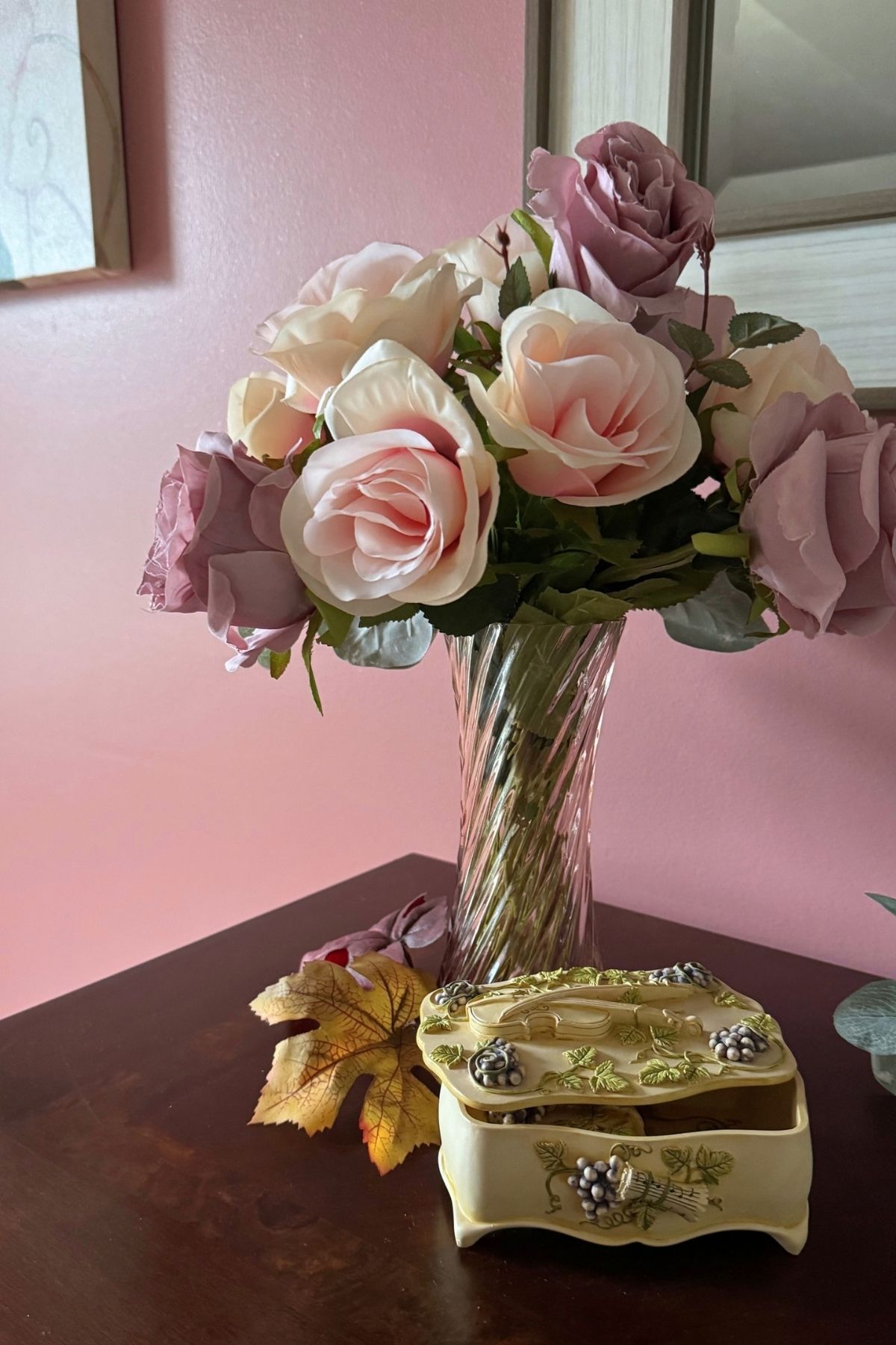 fall florals home decor A music box tucked next to fall florals in a pink glass vase