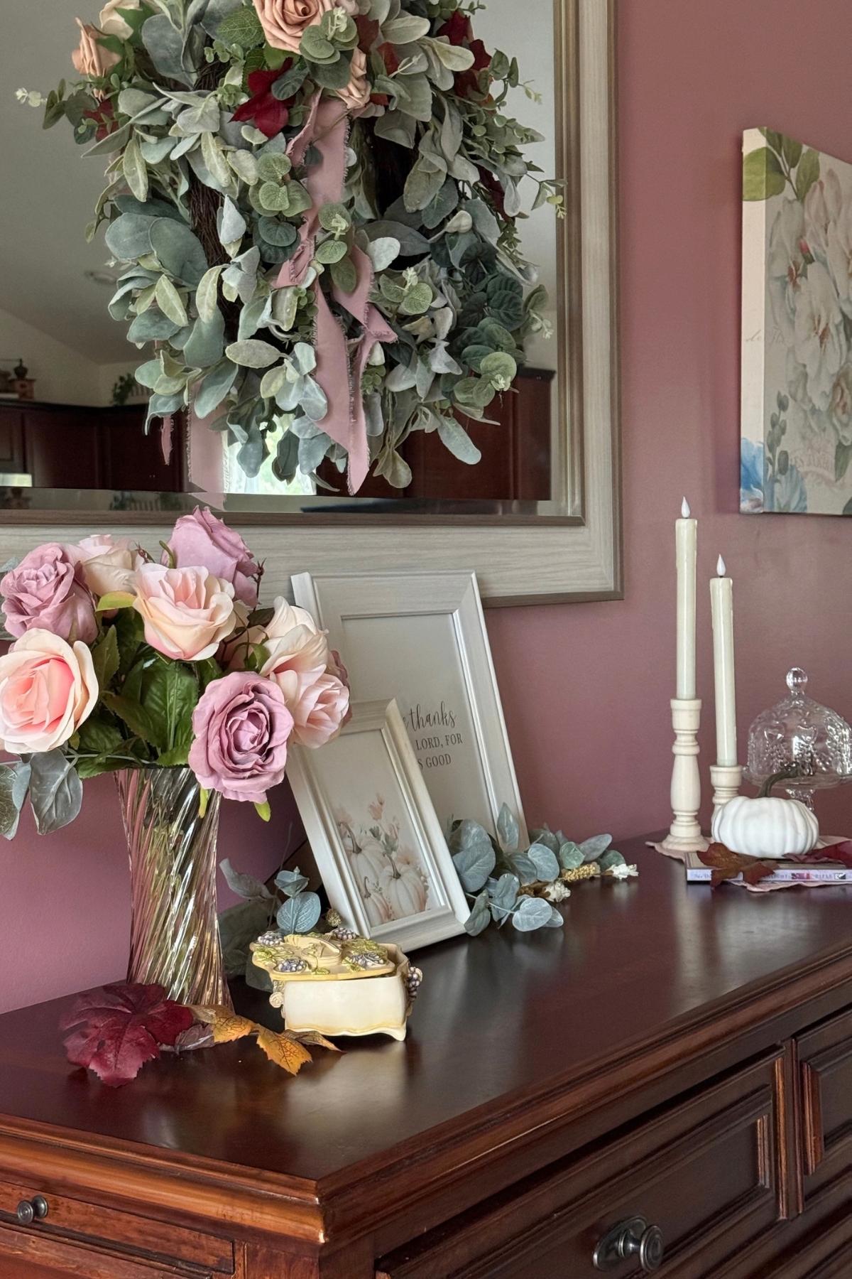 fall sideboard styling idea Fall sideboard decorated with faded roses, framed signs, candles, and a musicbox