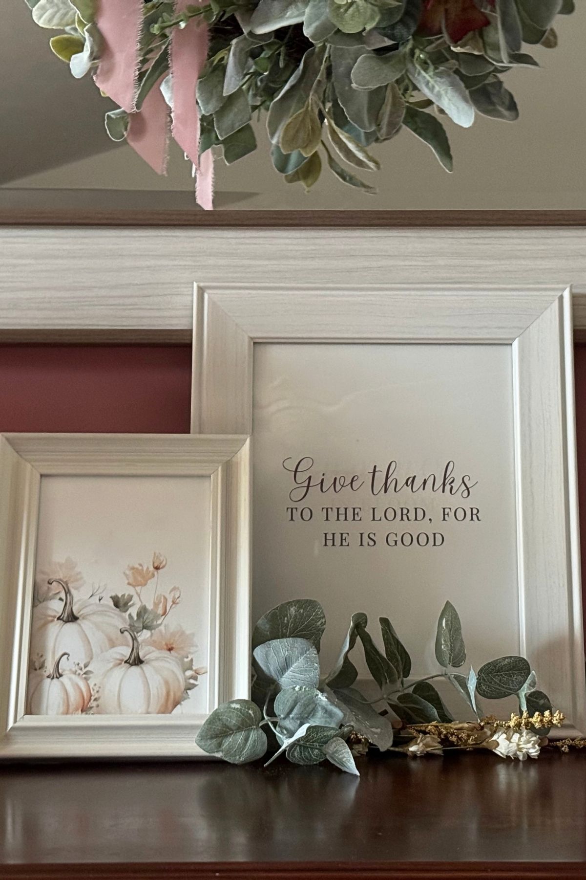 give thanks to the lord for he is good sign Two framed signs on a living room sideboard featuring cream pumpkins and text: Give thanks to the Lord for he is good.